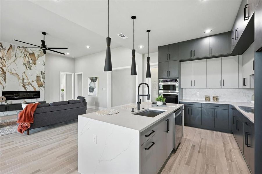 Kitchen featuring a ceiling fan, light wood-style floors, decorative backsplash, stainless steel appliances, and recessed lighting Kitchen featuring a ceiling fan, light wood-style floors, decorative backsplash, stainless steel appliances, and recessed lighting
