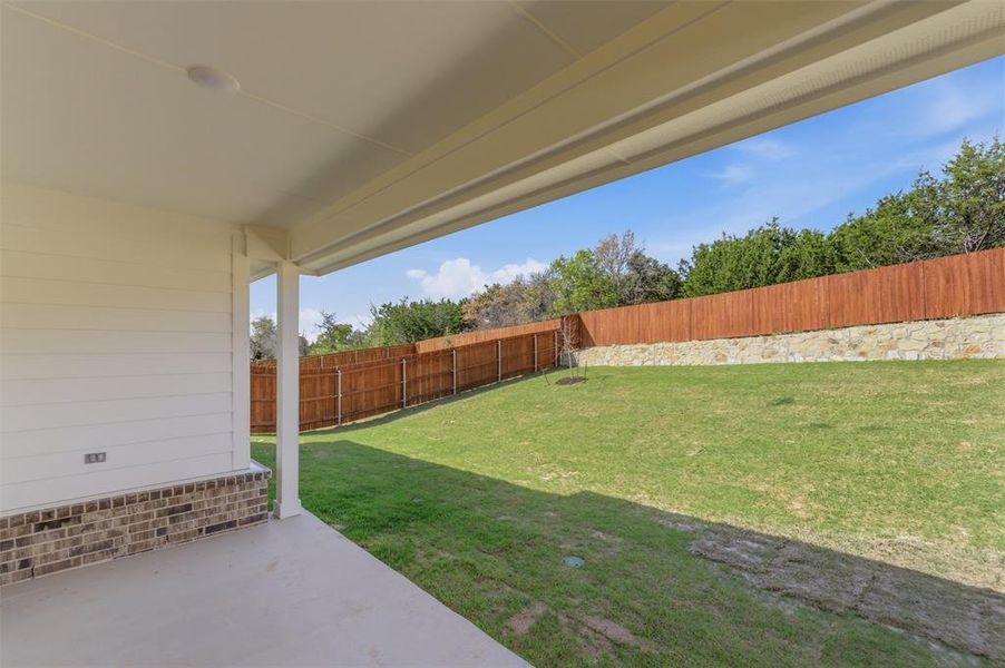Fenced backyard with a patio area