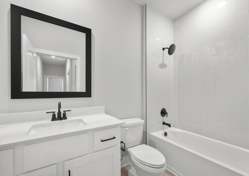 Second bathroom with a tub that has tile detail