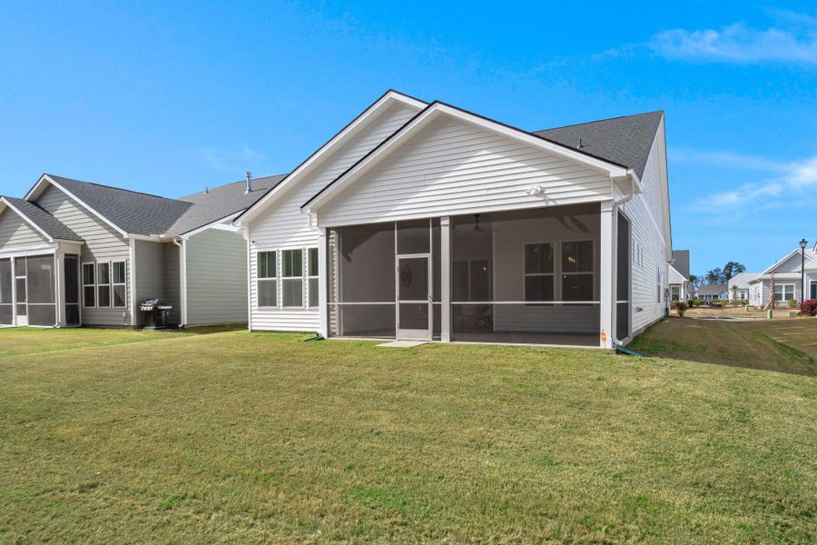Exterior details and patio area of a home in Summerwind Crossing at Lakes of Cane Bay, Summerville (Image 26).