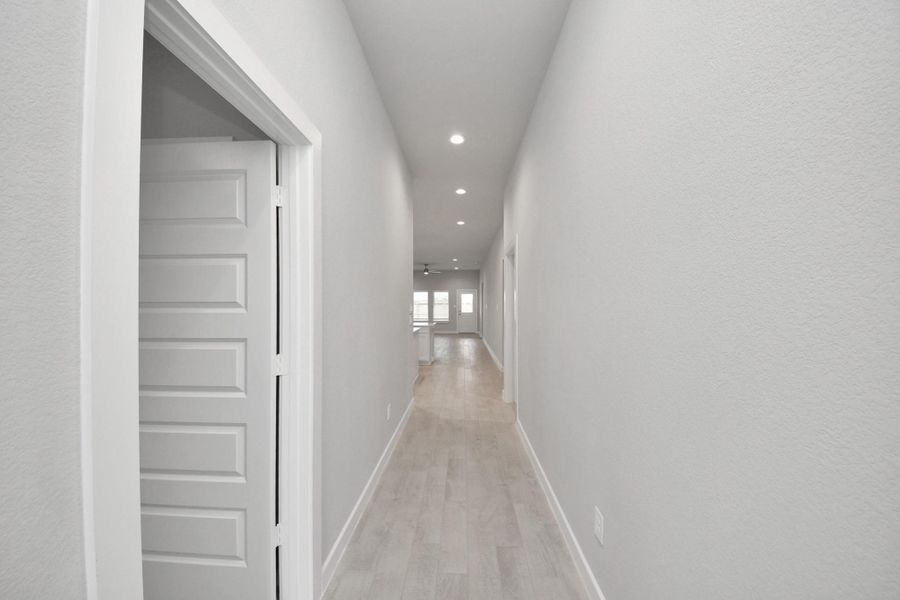 As you step into the threshold of this luxurious home, you'll soon be welcomed by an elegant glass door (to be installed). Inside, soaring ceilings amplify the spaciousness, while the refined wood-look tile flooring and oversized baseboards exude sophistication and charm. Sample photo of completed home with similar floor plan. Actual colors and selections may vary.