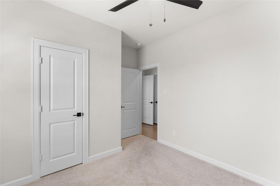 Secondary bedroom with plush carpet, ceiling fan, and a large window that fills the space with natural light. Perfect for family, guests, or a home office Secondary bedroom with plush carpet, ceiling fan, and a large window that fills the space with natural light. Perfect for family, guests, or a home office