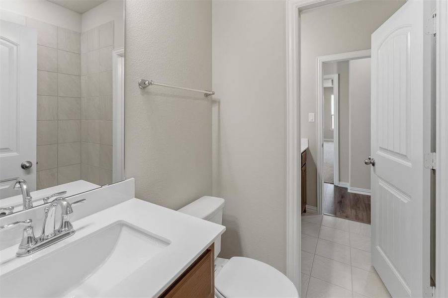 Full bathroom with vanity and light tile patterned floors
