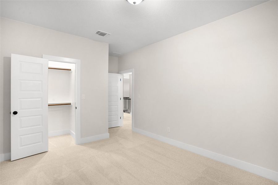 A well-proportioned bedroom with a functional closet. A well-proportioned bedroom with a functional closet.