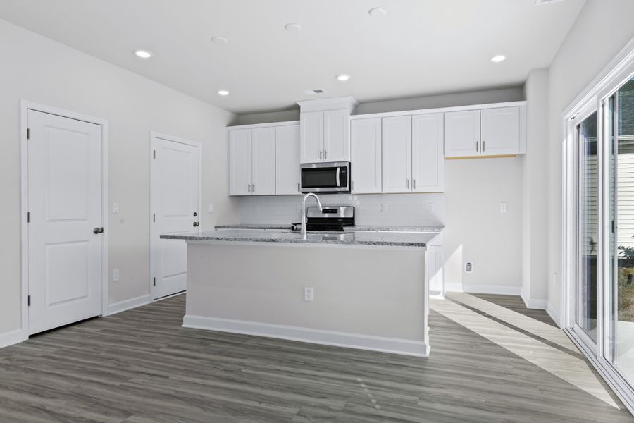 Enjoy preparing meals in this open kitchen with large work island. Enjoy preparing meals in this open kitchen with large work island.