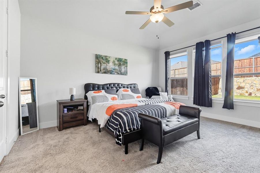 Bedroom featuring carpet floors and a ceiling fan Bedroom featuring carpet floors and a ceiling fan