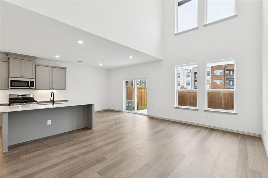 Our beautiful Baycliff plan features a wall of windows that flood the open concept main floor with natural light.