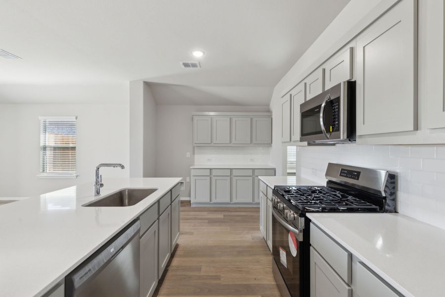 Kitchen in the Harrison home plan by Trophy Signature Homes – REPRESENTATIVE PHOTO