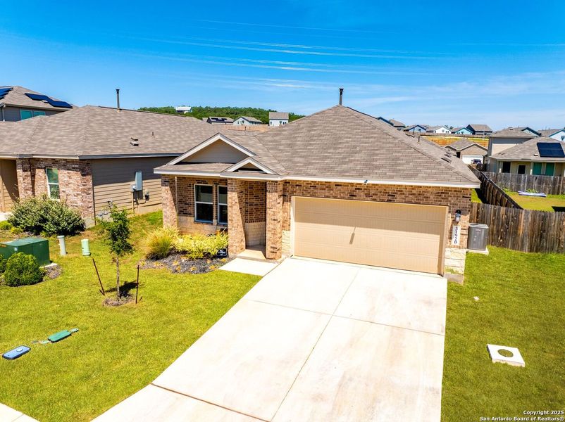 Front exterior of a new home in , Bulverde, TX, highlighting curb appeal (Image 25).