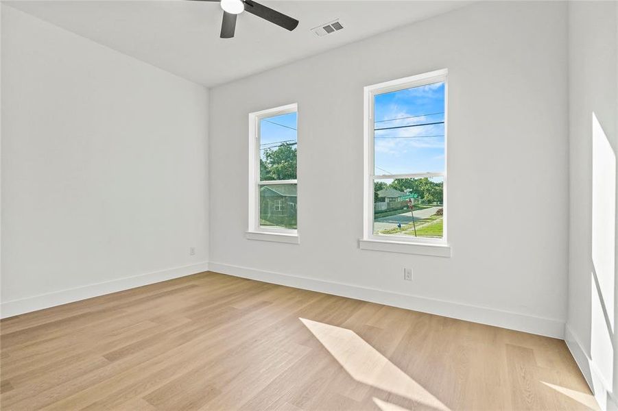 Spare room featuring light wood-style floors and a ceiling fan