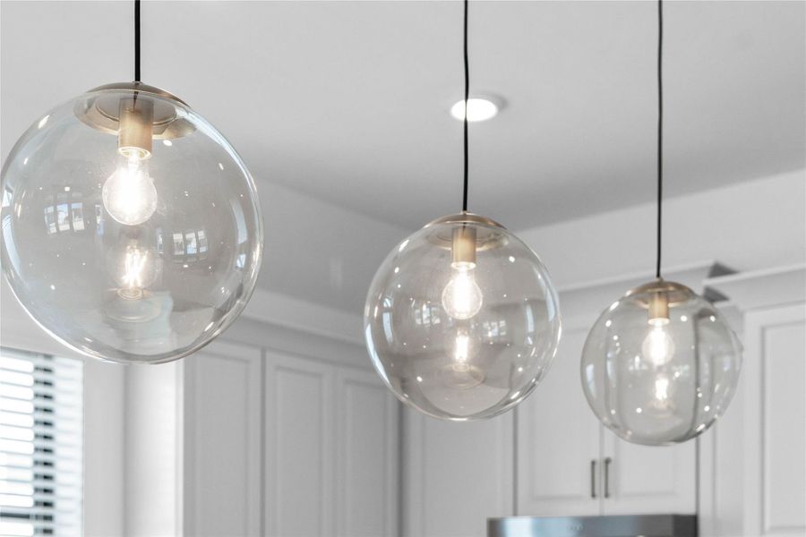 These sculptural 3-light globe pendants serve as a modern and sophisticated centerpiece over the kitchen island - giving added light into the kitchen and a sleek modern accent.