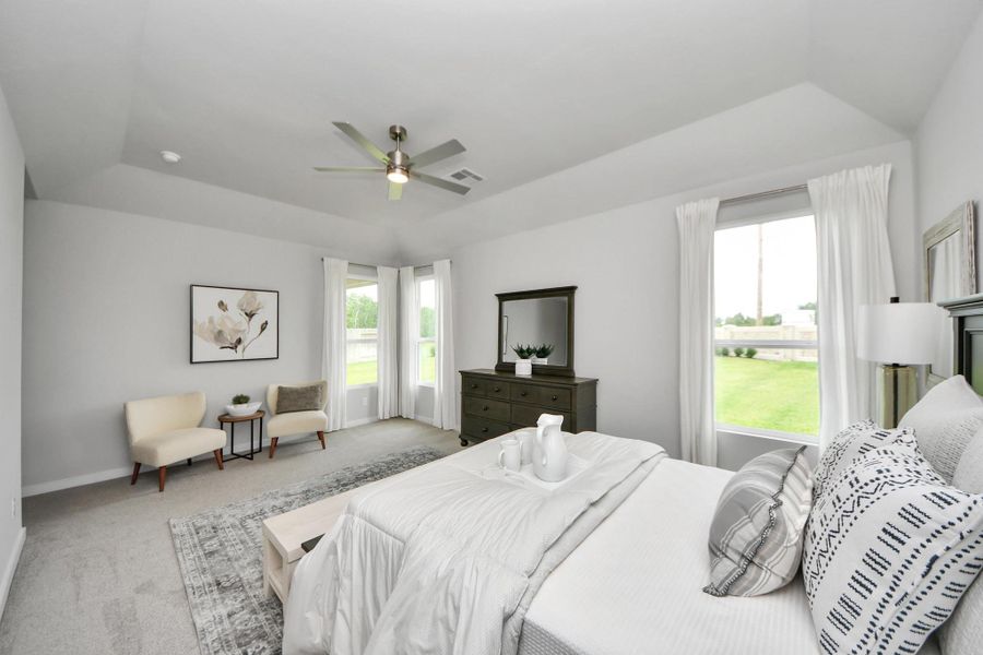 Another perspective unveils a comprehensive view of the serenity and comfort this primary suite offers! Sample photo of completed home with similar floor plan. Actual colors and selections may vary.