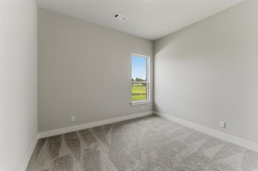 Spare room featuring light colored carpet and baseboards