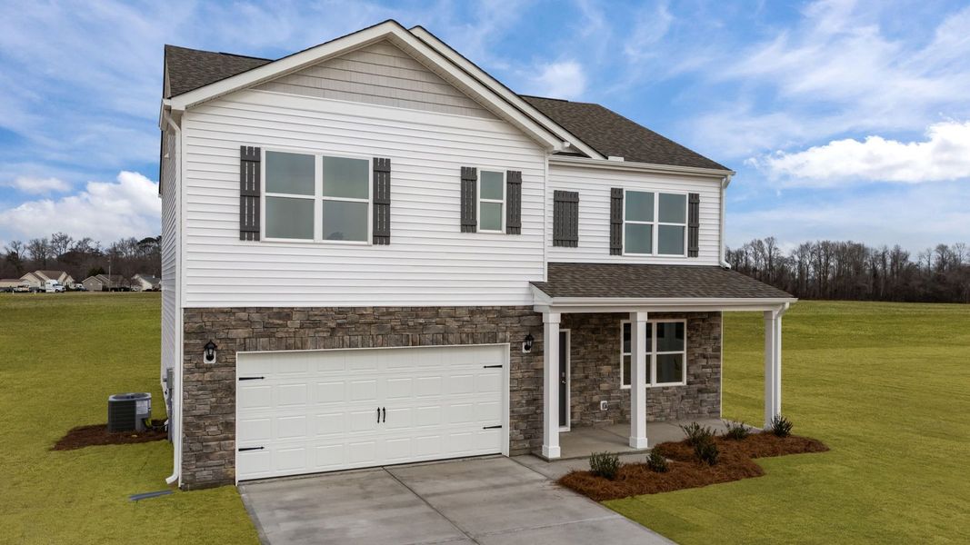 Front exterior of a new home in Ridgewood Farms, Winterville, NC, highlighting curb appeal (Image 2). Front exterior of a new home in Ridgewood Farms, Winterville, NC, highlighting curb appeal (Image 2).