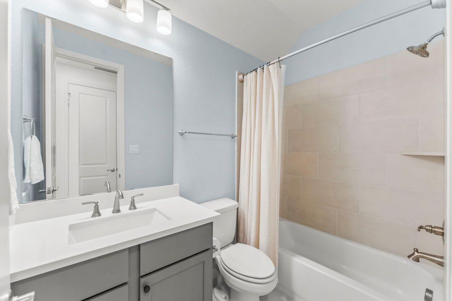Conveniently situated between the secondary bedrooms, this bathroom offers easy access from the living area.