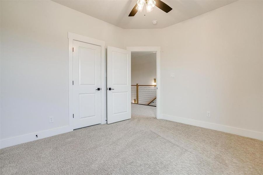 Unfurnished bedroom featuring carpet and ceiling fan