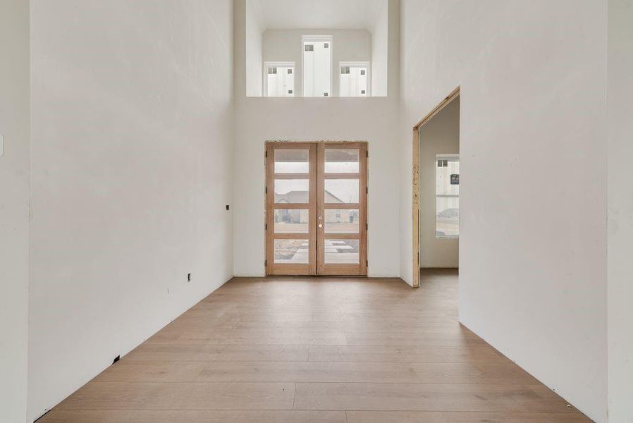 Stunning foyer with double front door & office on the right here.