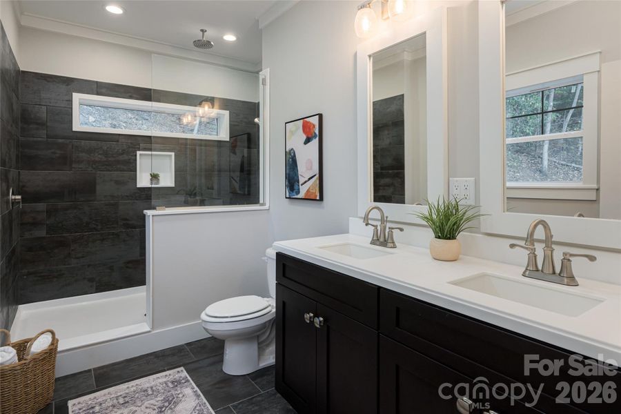 Primary bath with overside tiled shower with bench