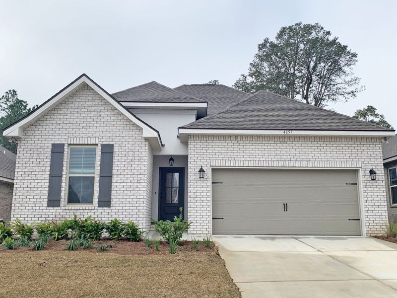 Front exterior of a new home in Sentinel Ridge, Pace, FL, highlighting curb appeal (Image 1).