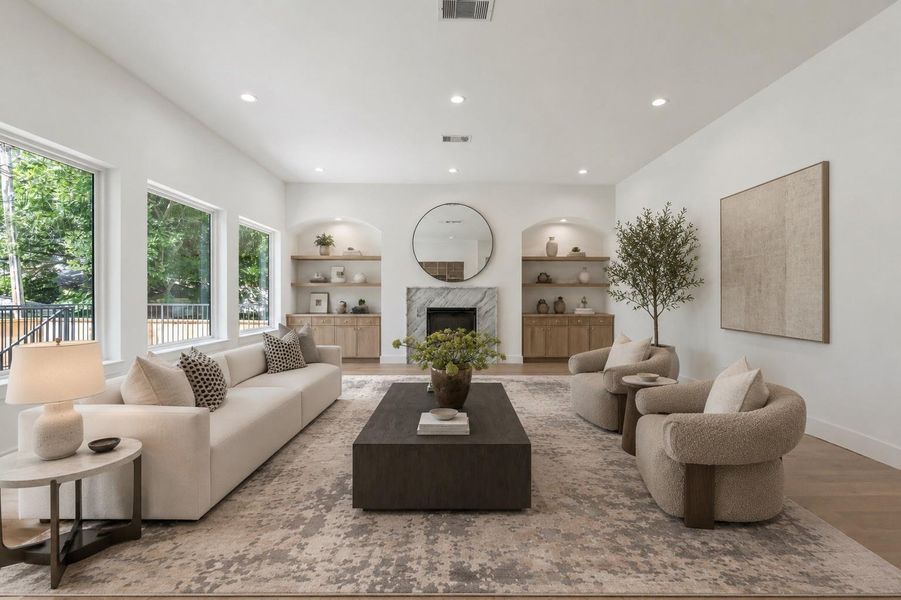 Living room highlighted by 11 foot ceilings and a custom marble chimney. Virtual staging.