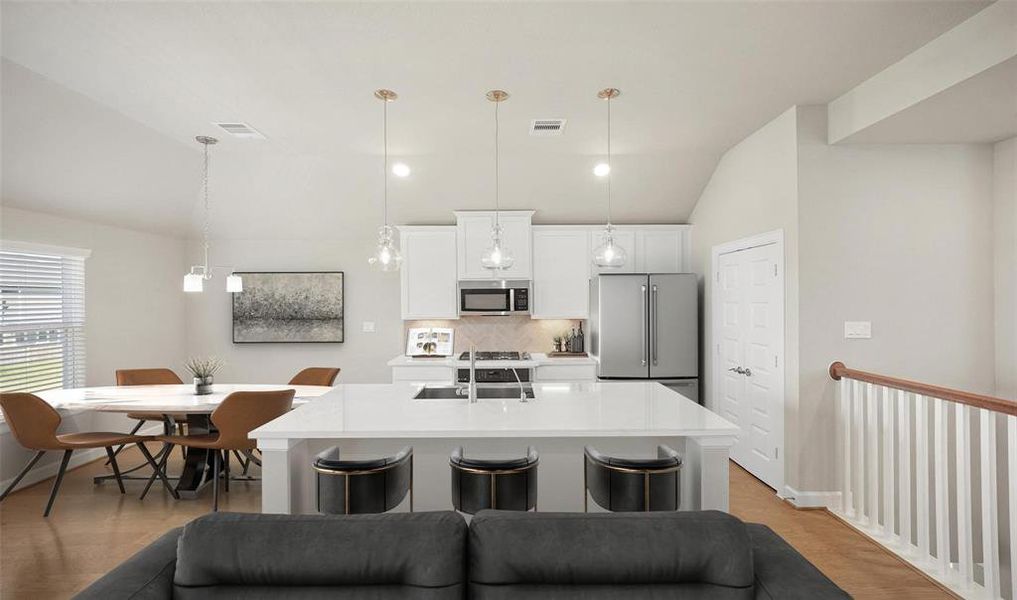 This beautiful island kitchen with quartz countertops.