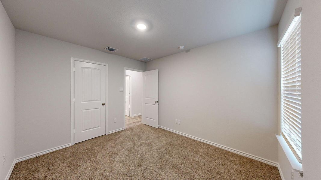 Unfurnished bedroom featuring carpet and baseboards