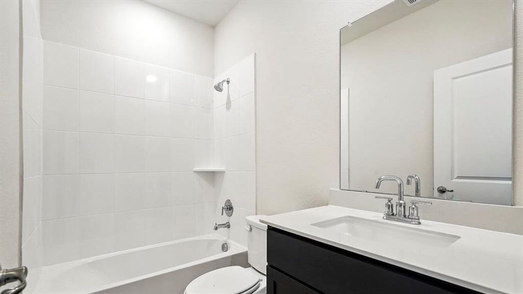 Bathroom featuring vanity and shower / tub combination