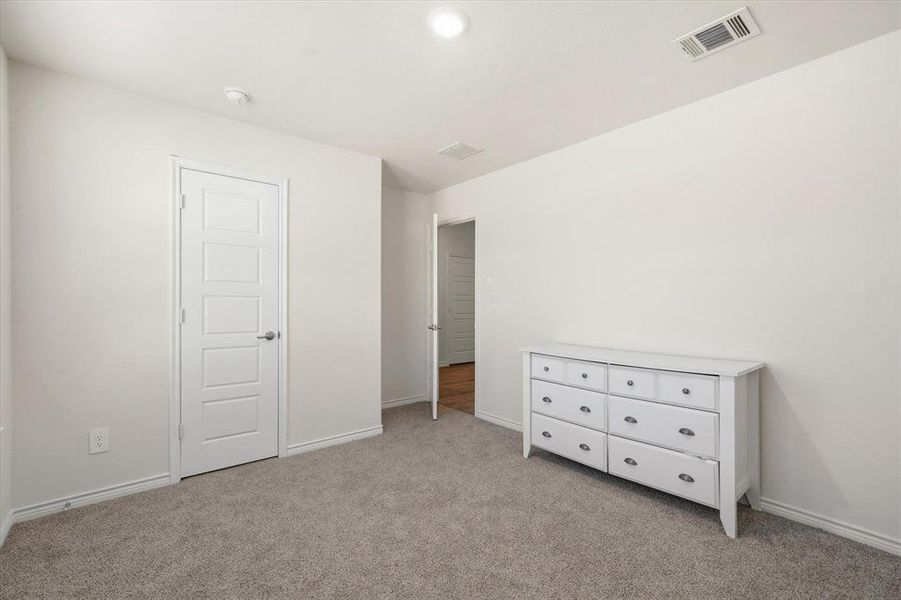 bedroom with baseboards and light colored carpet bedroom with baseboards and light colored carpet