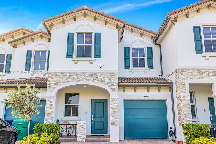 Front exterior of a new home in Westview: Nantucket Collection, Miami, FL, highlighting curb appeal (Image 22). Front exterior of a new home in Westview: Nantucket Collection, Miami, FL, highlighting curb appeal (Image 22).