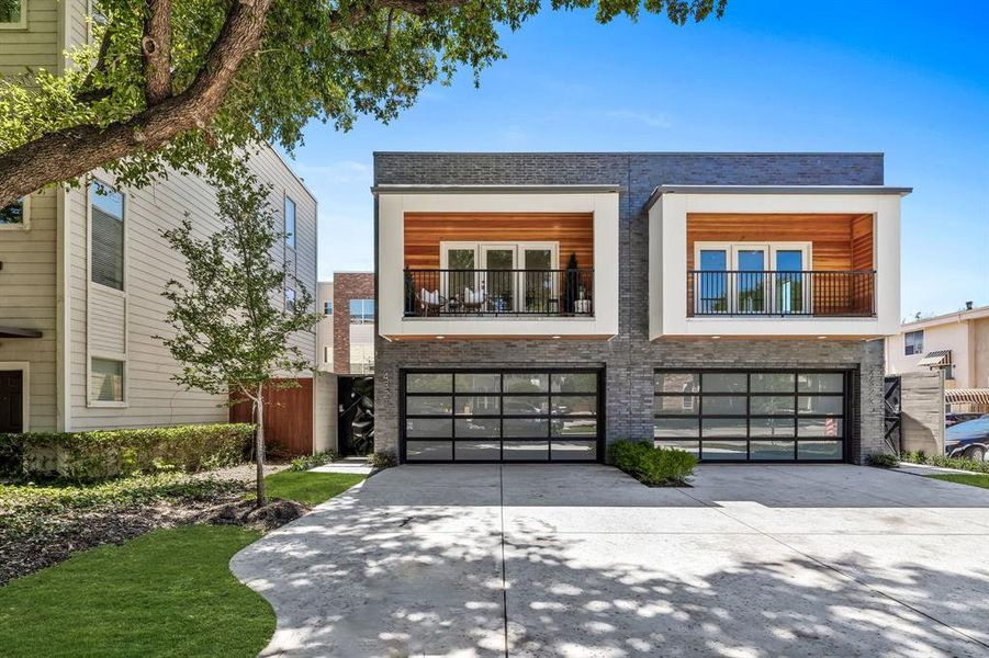 Modern home featuring a garage and a balcony