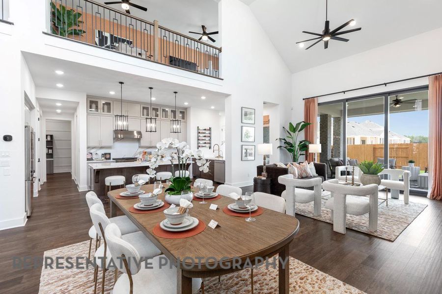 Dining space with ceiling fan, dark wood finished floors, high vaulted ceiling, and recessed lighting