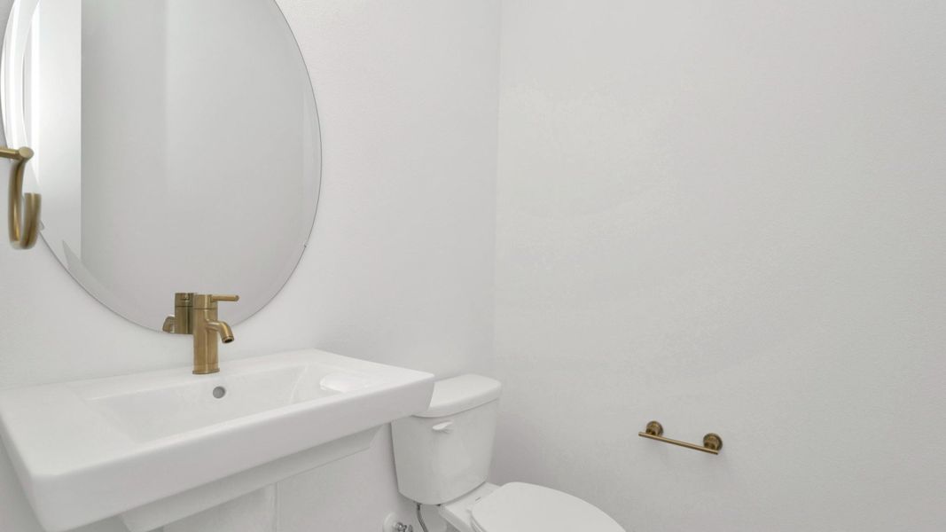 The Half Bathroom of a DRB Homes Grand Hawk which is offered as a home plan at Serengeti in Spring Hill, FL.