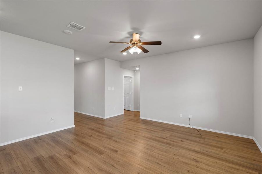 Unfurnished room with light wood finished floors, recessed lighting, and a ceiling fan Unfurnished room with light wood finished floors, recessed lighting, and a ceiling fan