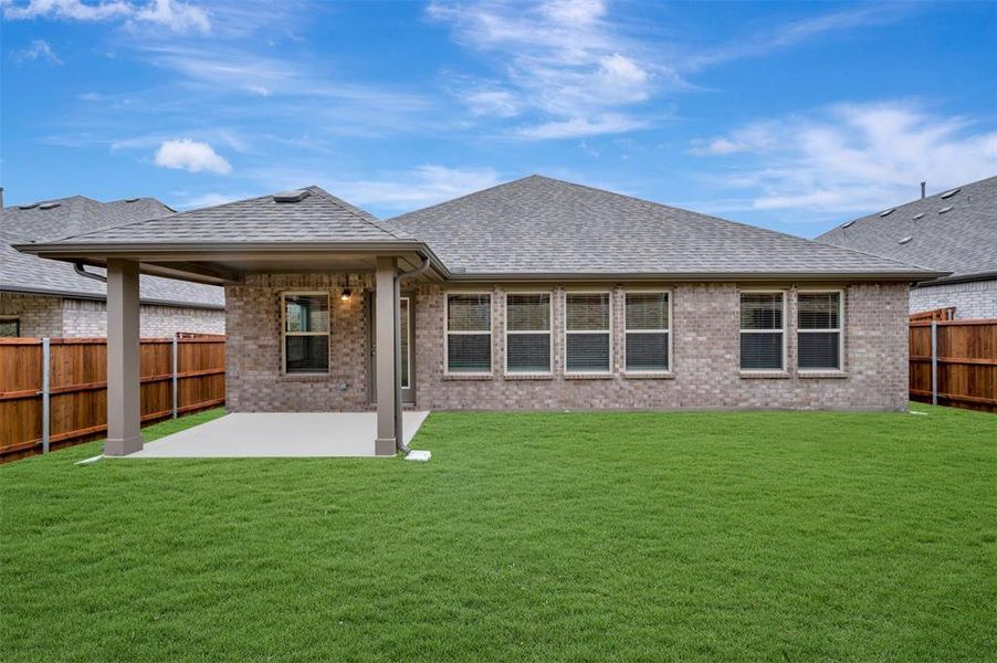 Exterior details and patio area of a home in Woodstone, Providence Village (Image 4).