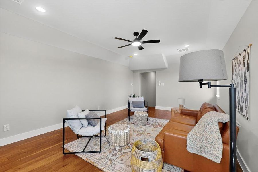Living area featuring a ceiling fan, wood finished floors, and recessed lighting