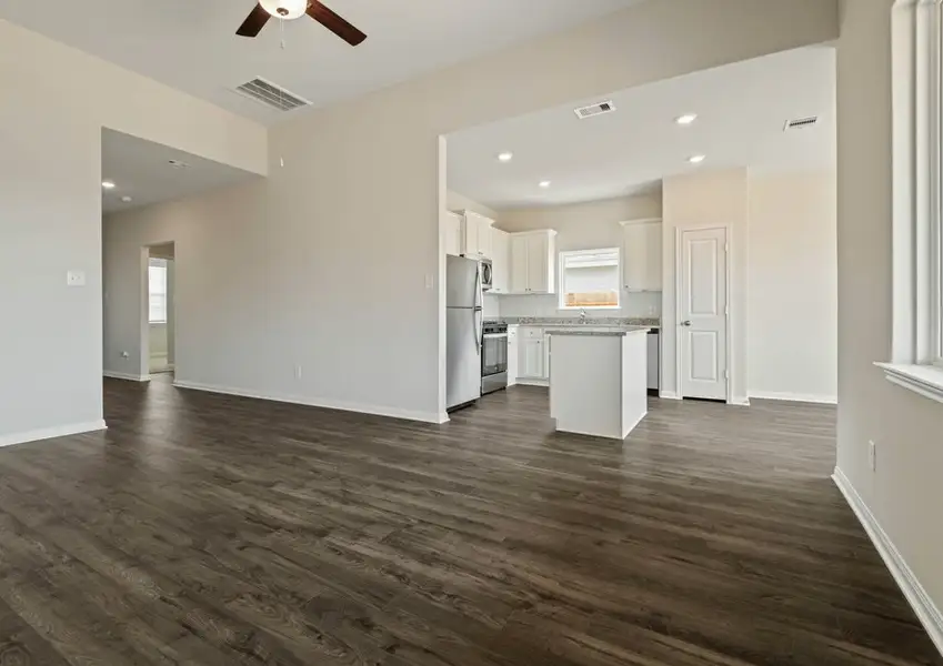 Spacious family room with a window overlooking the back yard