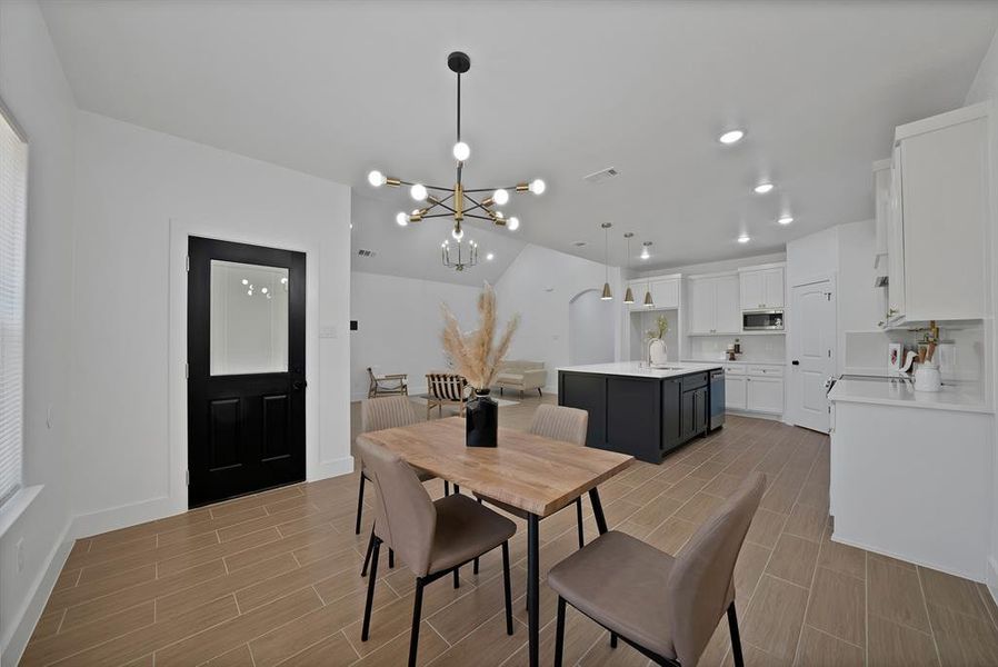 Dining area with tiled finish floors, a chandelier, and recessed lighting