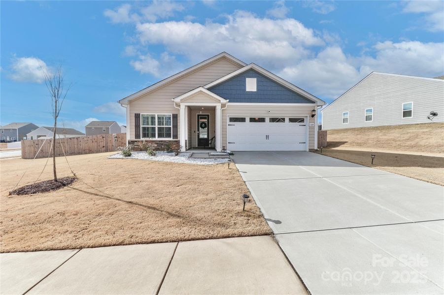 Front exterior of a new home in Colonial Crossing, Troutman, NC, highlighting curb appeal (Image 2). Front exterior of a new home in Colonial Crossing, Troutman, NC, highlighting curb appeal (Image 2).