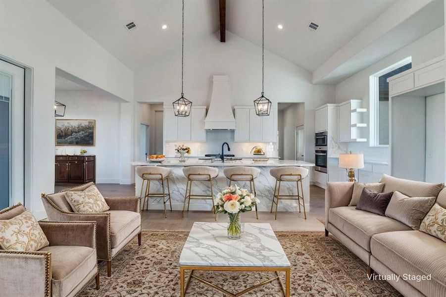 Living room with high vaulted ceiling and beamed ceiling