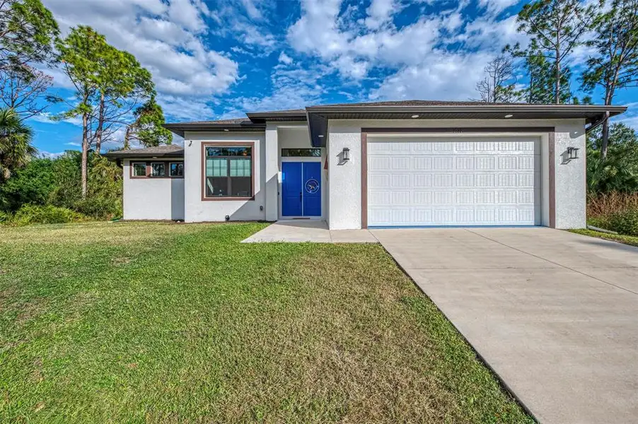 Front exterior of a new home in , North Port, FL, highlighting curb appeal (Image 1).