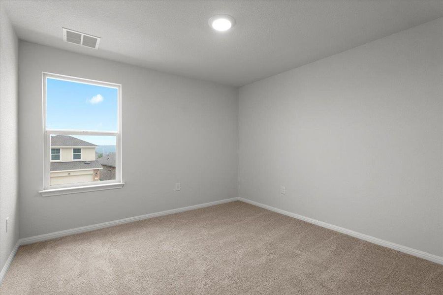 Neutral-toned room featuring a single window with white trim, recessed ceiling lighting, and carpet flooring