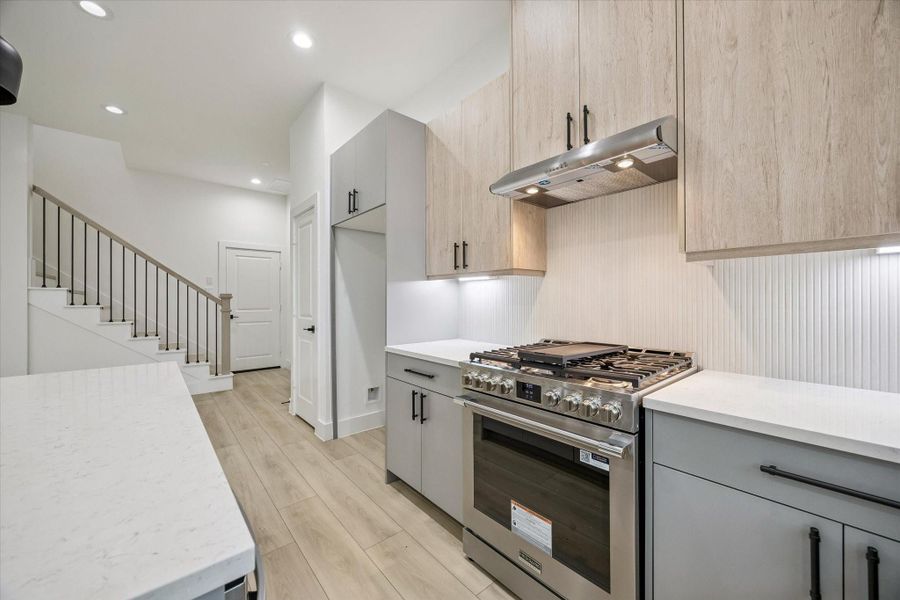 Well-appointed kitchen featuring stainless appliances and stylish backsplash Well-appointed kitchen featuring stainless appliances and stylish backsplash