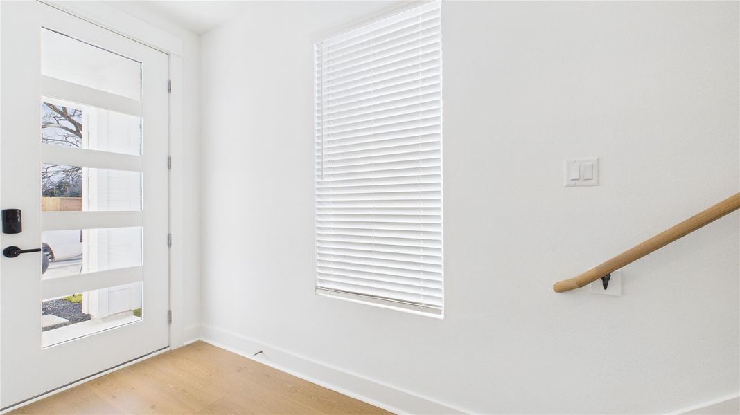 The welcoming foyer, located just off the front door, provides convenient access to the secondary bedroom and the garage, creating a functional and well-organized entry that sets the tone for the home’s thoughtful layout.