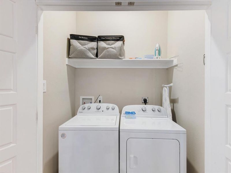 Washroom featuring washing machine and dryer