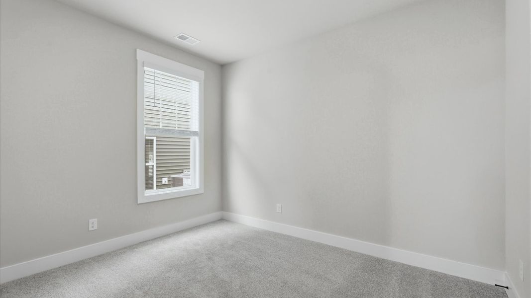 Refined bedroom design with large windows for daylight-filled mornings and peaceful views