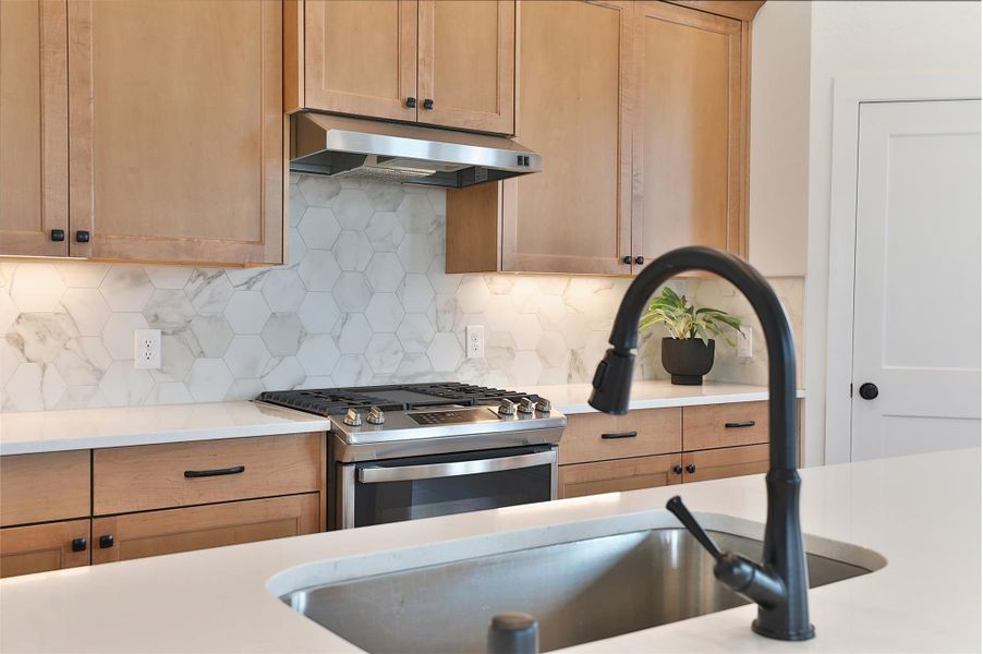 The woven backsplash adds a touch of unique detail and thoughtful design, elevating the overall charm of the kitchen. The woven backsplash adds a touch of unique detail and thoughtful design, elevating the overall charm of the kitchen.