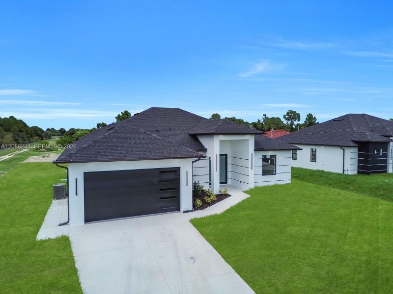 Front exterior of a new home in , Lehigh Acres, FL, highlighting curb appeal (Image 18).