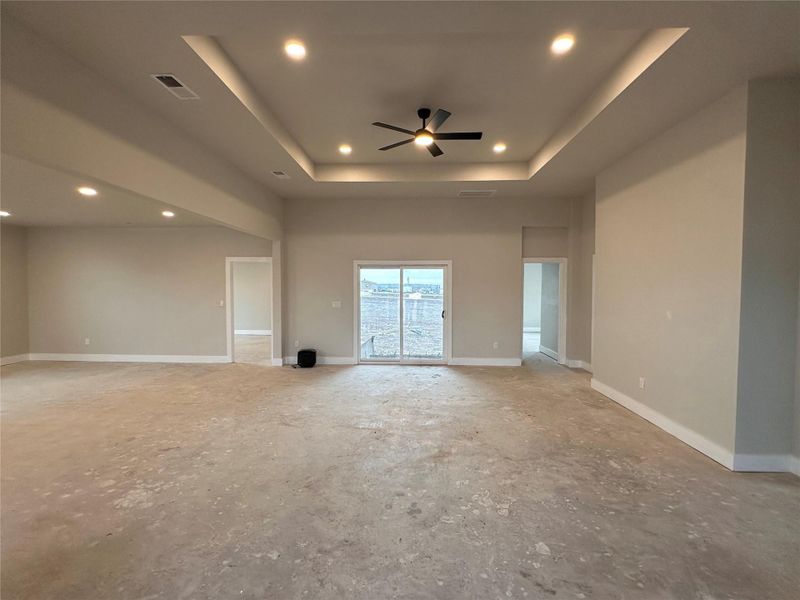 Spare room with ceiling fan, recessed lighting, and a raised ceiling
