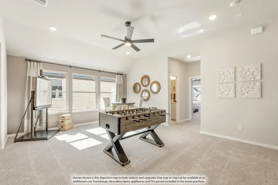 Bonus room with foosball table, vaulted ceiling, ceiling fan, and carpet flooring Bonus room with foosball table, vaulted ceiling, ceiling fan, and carpet flooring