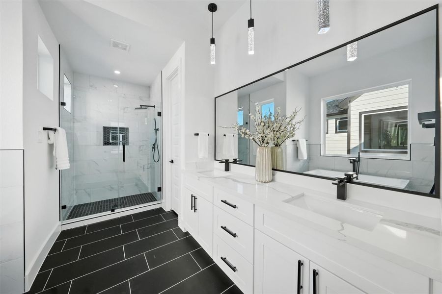 Elegant spa-style bathroom with a modern, clean design, featuring a frameless glass walk-in shower with designer tile, dual vanities with Quartz countertops, and sleek black fixtures. The spacious layout, large mirror, and contemporary lighting create a refined and relaxing retreat with a high-end feel. Elegant spa-style bathroom with a modern, clean design, featuring a frameless glass walk-in shower with designer tile, dual vanities with Quartz countertops, and sleek black fixtures. The spacious layout, large mirror, and contemporary lighting create a refined and relaxing retreat with a high-end feel.